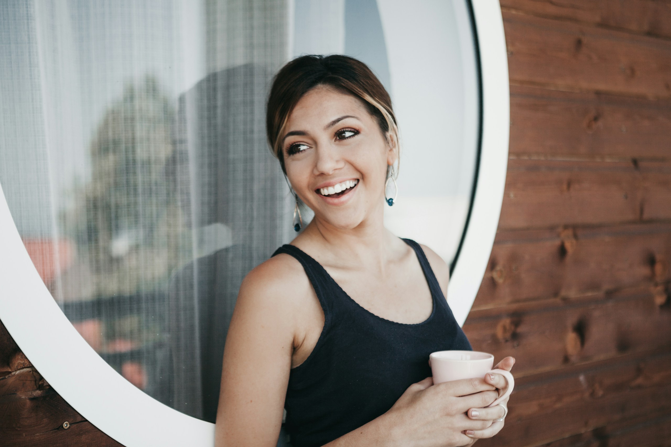 woman-wearing-black-tank-top-holding-mug-stockpack-unsplash